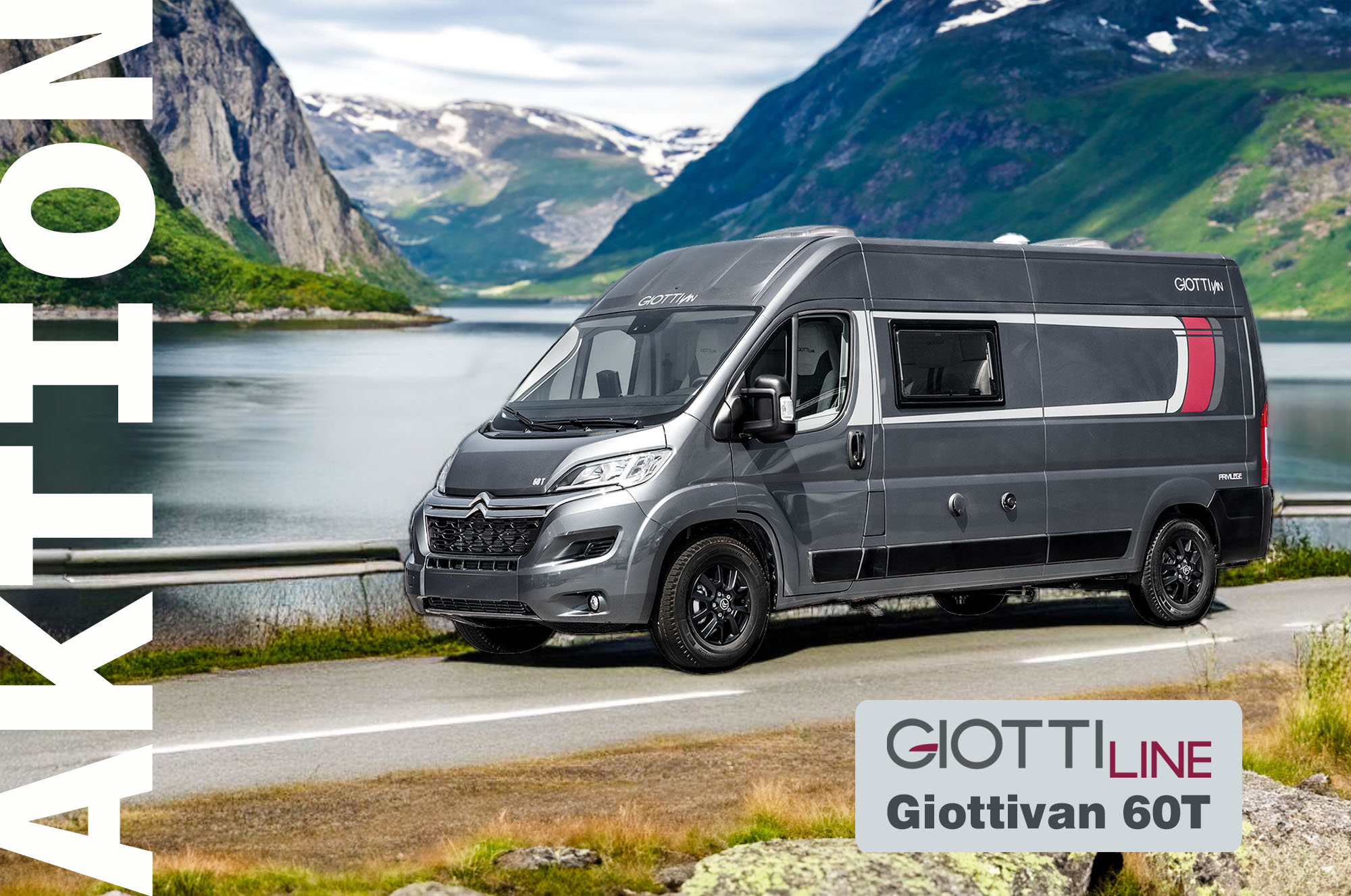 Grauer Van von Giootiline auf der Straße stehen an einem See und im Hintergrund ist eine beeindrucke Bergkulisse zu sehen.